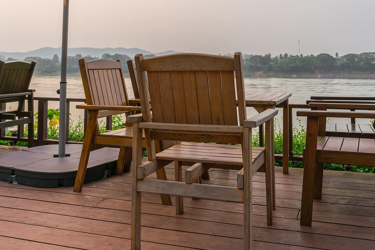 Wooden deck with chairs overlooking a river – Trent Hills deck repair experts