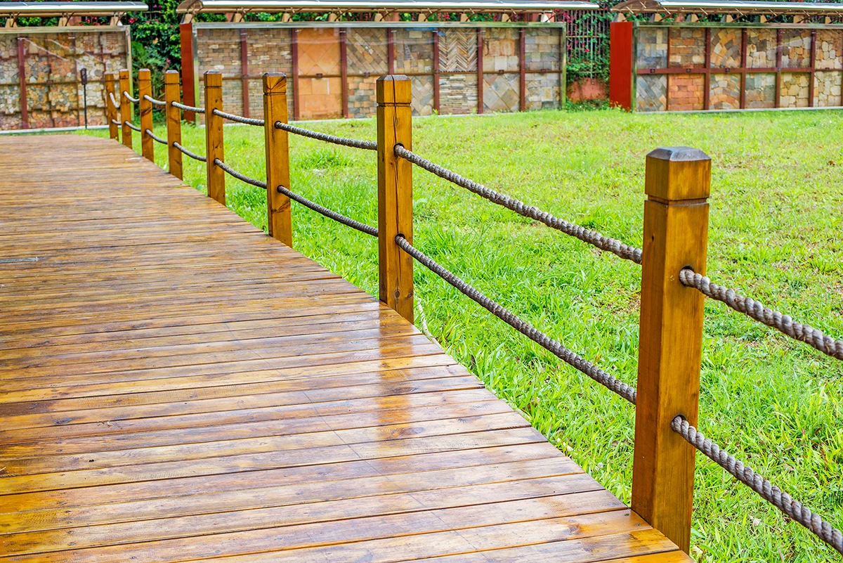 Glossy wet deck surface with rope railing – Trent Hills deck repair experts