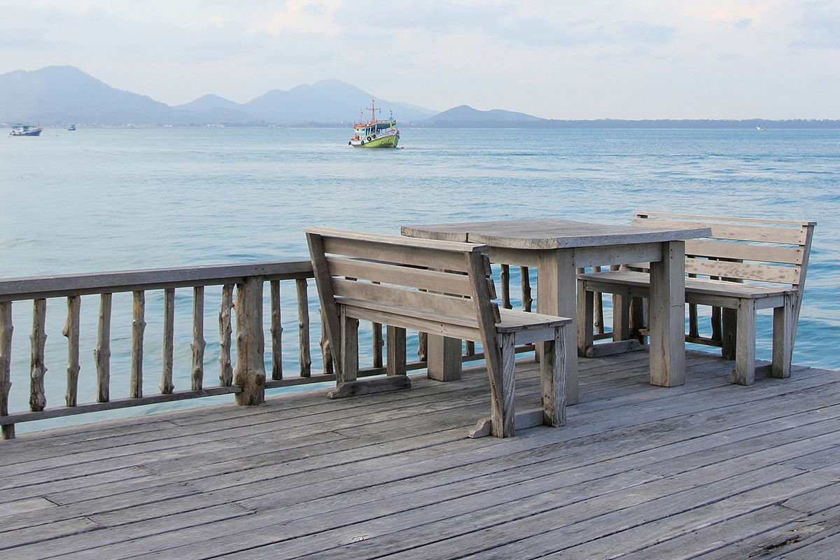Waterfront deck view with wooden seating – custom deck builds in Havelock by Renossance