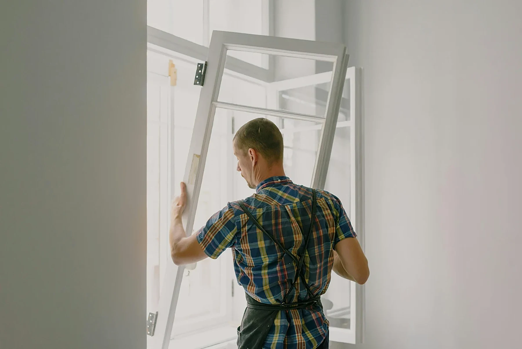 Professional contractor installing a new energy-efficient window – Renossance shows the real cost of window installation.