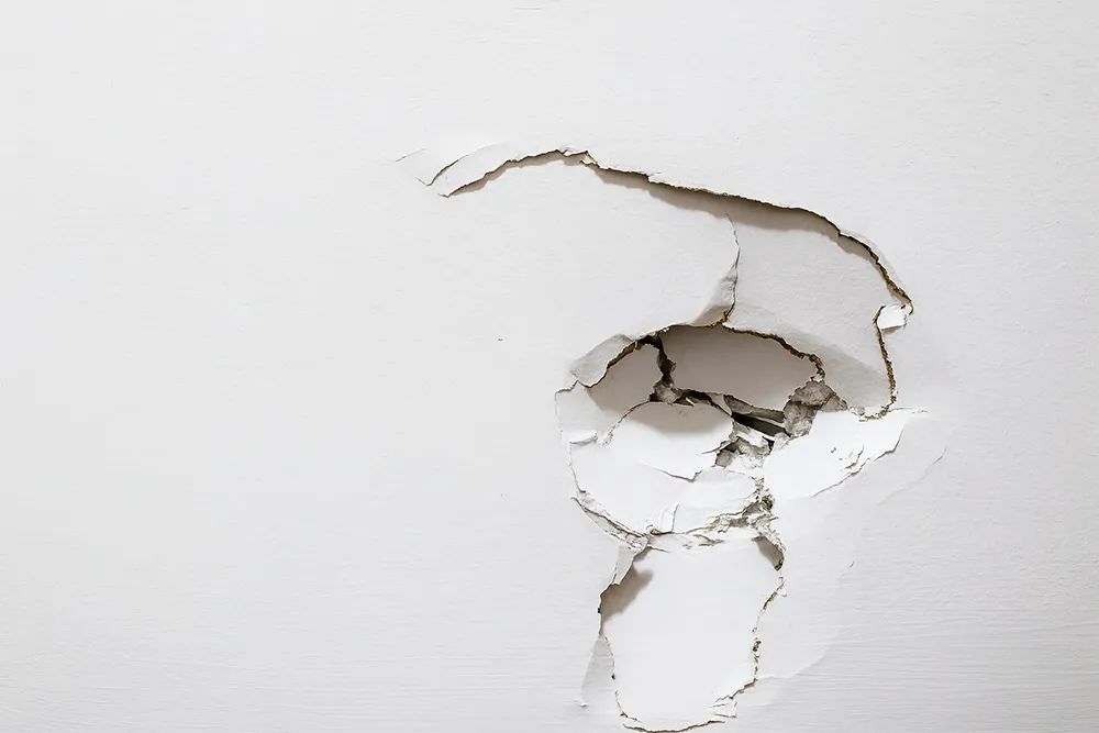 drywall repair in Trent Hills showing damaged wall before professional restoration by Renossance