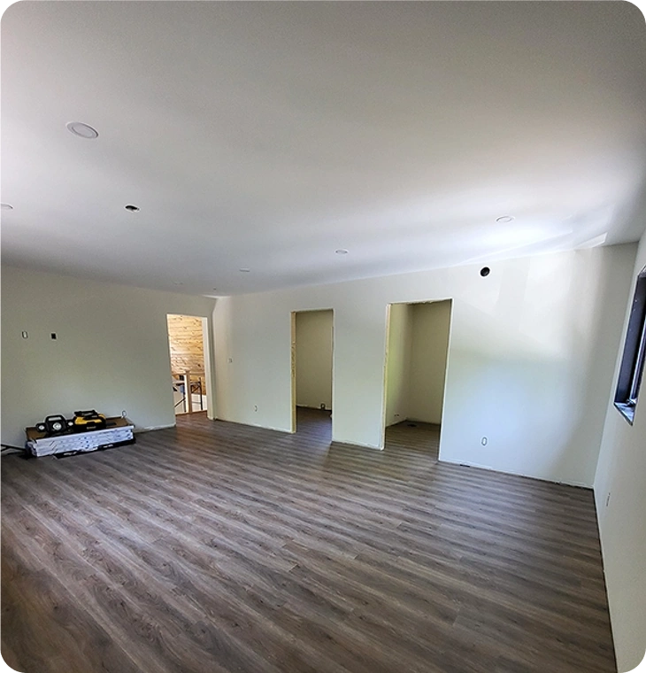 Open-concept basement renovations Norwood by Renossance with new flooring and framed rooms.