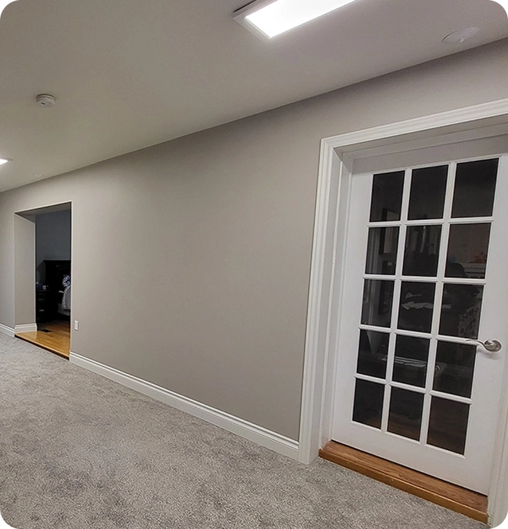 Carpeted hallway with French doors from basement renovations Warkworth by Renossance.