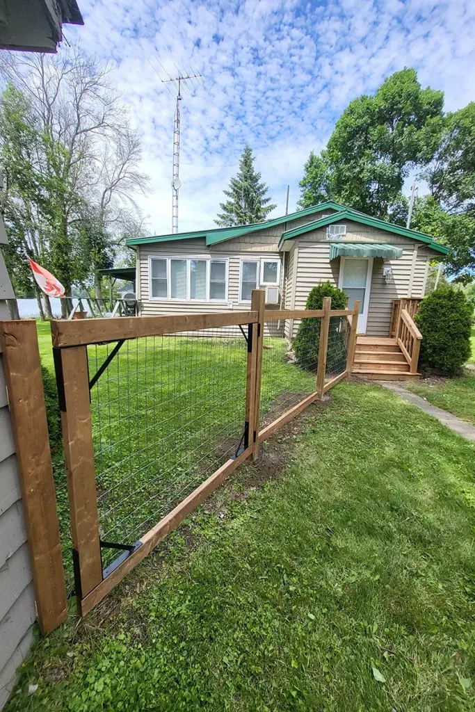 Wooden and wire fence by residential home — Fence Installation and Fence Repair Hastings by Renossance