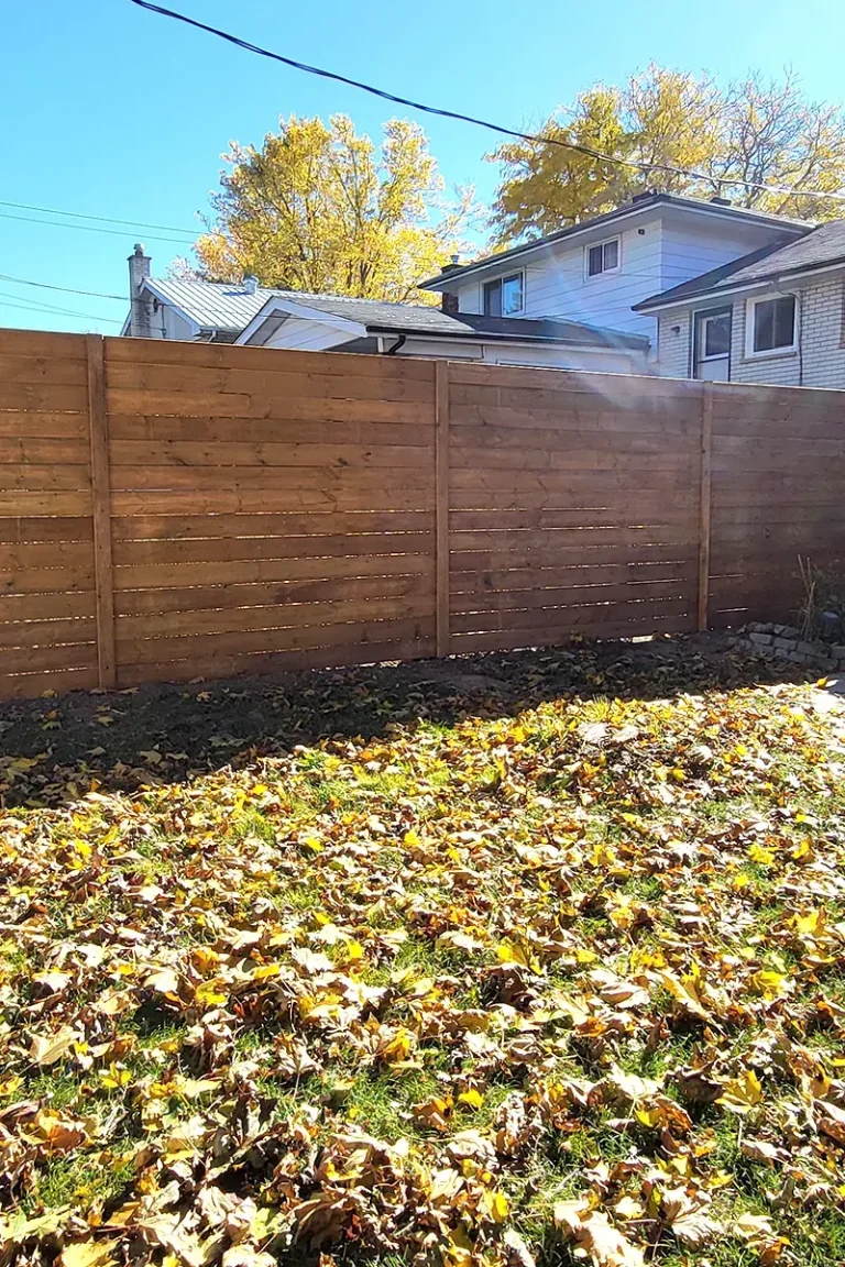 Wooden privacy fence with autumn leaves — Fence Installation and Fence Repair Norwood by Renossance