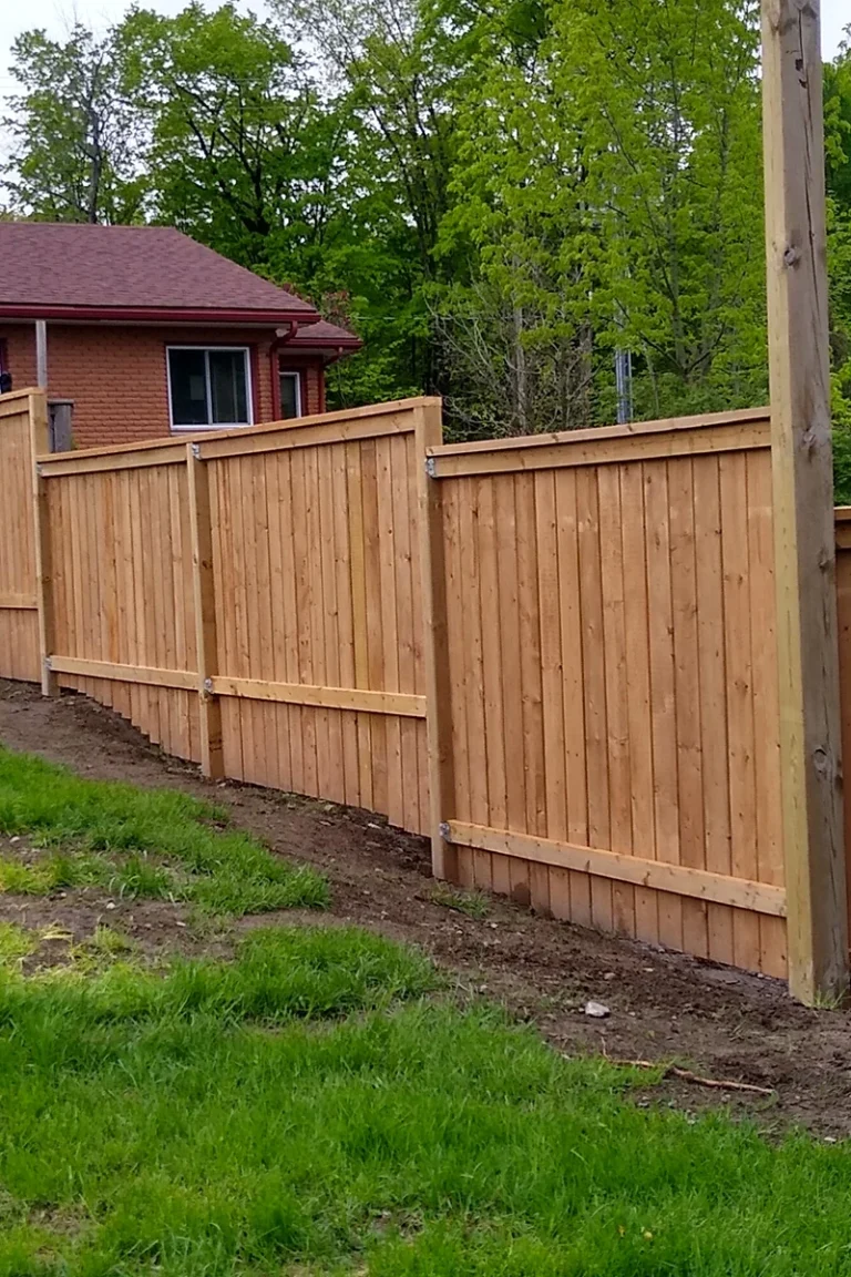 Tall wooden privacy fence by house — Fence Installation and Fence Repair Trent Hills by Renossance
