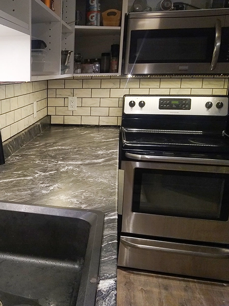 Updated backsplash and appliances from a kitchen renovation in Campbellford by Renossance.