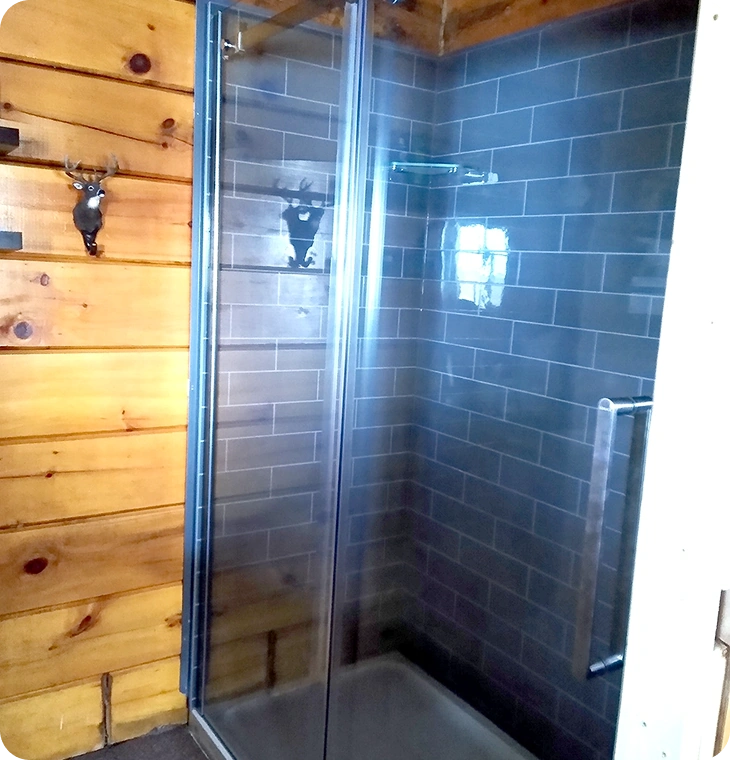 Custom shower with glass door and wood-accent walls – Bathroom Renovations Marmora, ON by Renossance