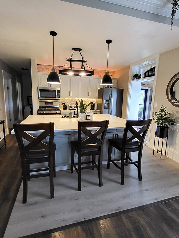 Spacious kitchen renovations Havelock by Renossance featuring island seating and elegant lighting.