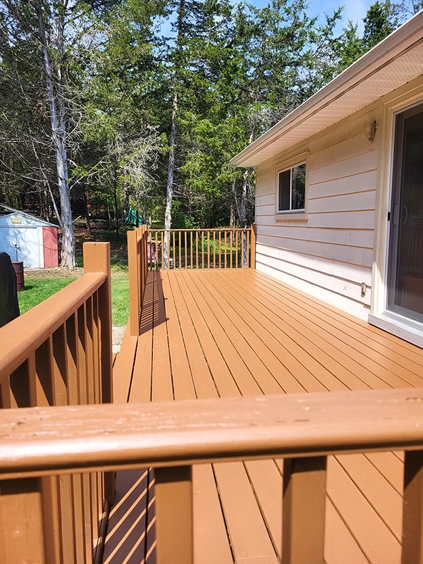 Newly stained wood deck with railings in backyard – Deck Repair and Deck Installation Marmora, ON