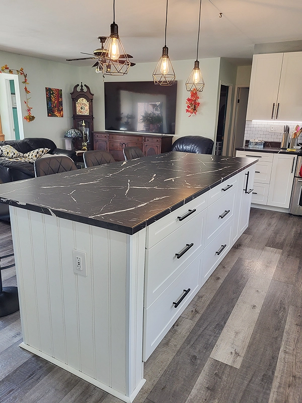Large island with black marble top from a kitchen renovations Trent Hills by Renossance.