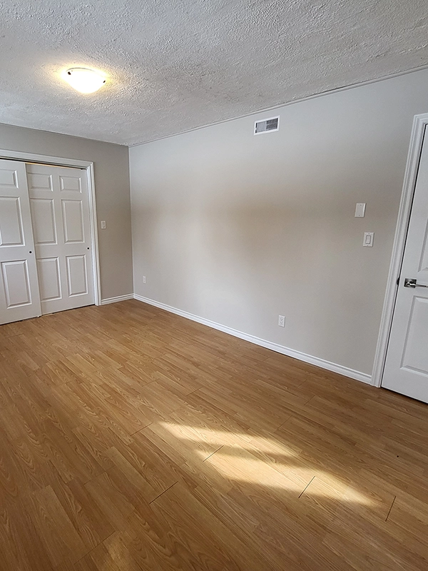 Finished room with wood-look flooring from basement renovations Trent Hills by Renossance.