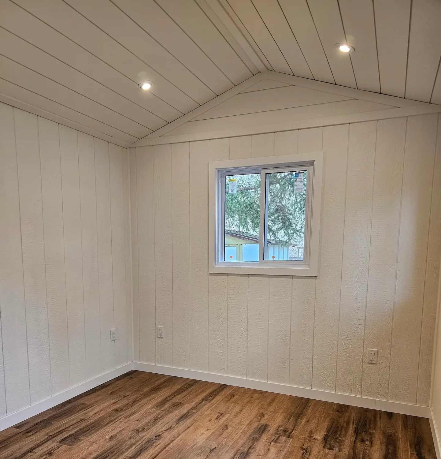 Painted white shiplap interior walls and ceiling in Havelock cottage by Renossance