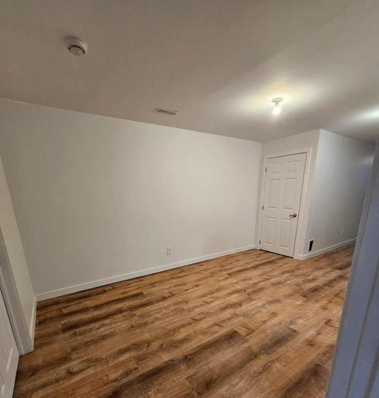 Freshly painted white basement walls and drywall finish in Stirling-Rawdon home by Renossance